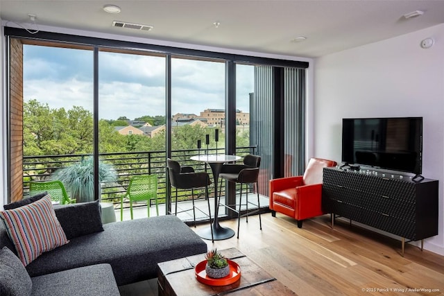 900 S 1st St Unit 416, Austin, TX 78704 - living room featuring light wood-style floors, plenty of natural light, and floor to ceiling windows