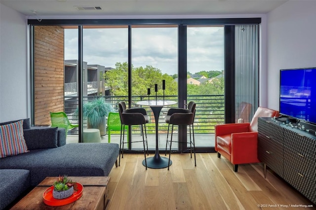900 S 1st St Unit 416, Austin, TX 78704 - living room with expansive windows, wood finished floors, and plenty of natural light