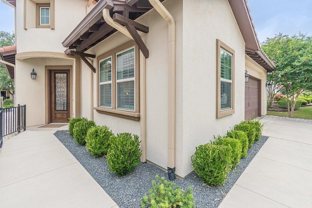 213 Sowing Oak Dr, San Marcos, TX 78666 - doorway to property with stucco siding and driveway