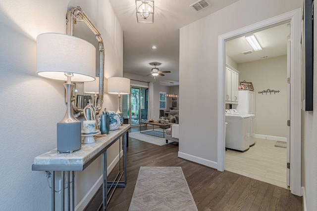 213 Sowing Oak Dr, San Marcos, TX 78666 - hall with dark wood finished floors, baseboards, and separate washer and dryer