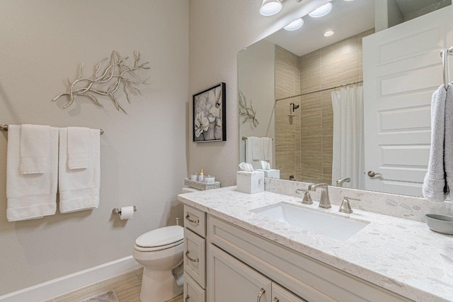 213 Sowing Oak Dr, San Marcos, TX 78666 - bathroom featuring a tile shower, toilet, vanity, baseboards, and wood finished floors