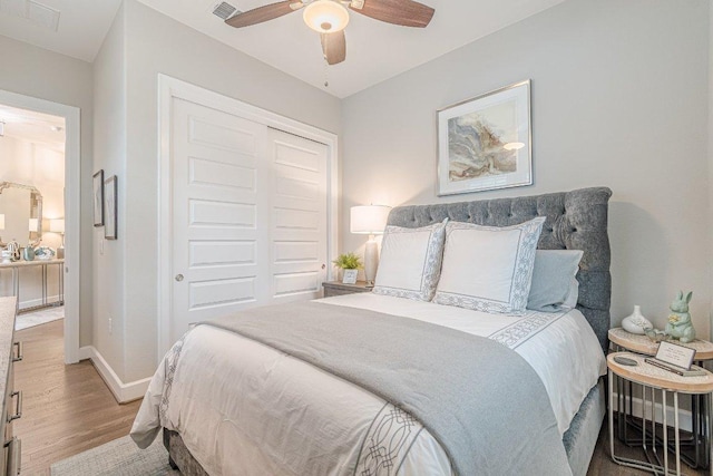 213 Sowing Oak Dr, San Marcos, TX 78666 - bedroom with wood finished floors, a closet, baseboards, and a ceiling fan