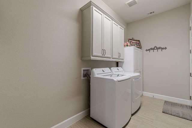 213 Sowing Oak Dr, San Marcos, TX 78666 - laundry room featuring cabinet space, washing machine and dryer, and baseboards