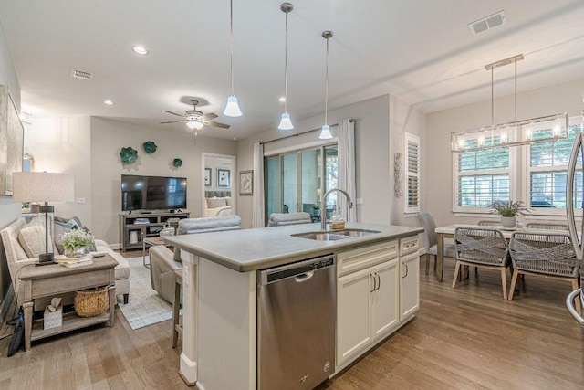 213 Sowing Oak Dr, San Marcos, TX 78666 - kitchen featuring dishwasher, a sink, light wood-style floors, an island with sink, and open floor plan