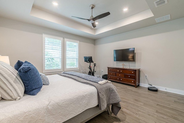 433 Skipping Cedar St, San Marcos, TX 78666 - bedroom with a tray ceiling, light wood finished floors, baseboards, ceiling fan, and recessed lighting