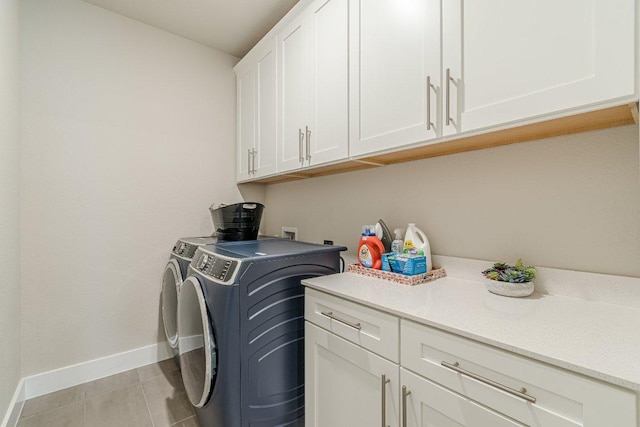 433 Skipping Cedar St, San Marcos, TX 78666 - laundry area featuring cabinet space, baseboards, washer and clothes dryer, and light tile patterned flooring