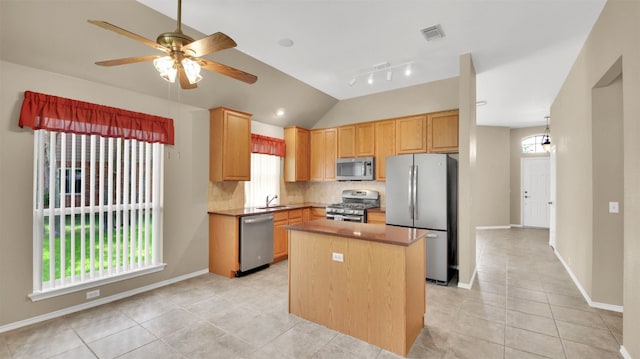 1803 Shooting Star Cv, Cedar Park, TX 78613 - kitchen with stainless steel appliances, light tile patterned floors, decorative backsplash, plenty of natural light, and vaulted ceiling