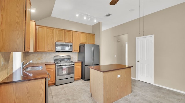 1803 Shooting Star Cv, Cedar Park, TX 78613 - kitchen featuring stainless steel appliances, a kitchen island, backsplash, lofted ceiling, and light tile patterned floors