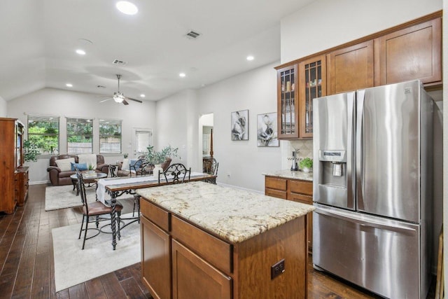 2228 Hilltop Climb Dr, Leander, TX 78641 - kitchen with stainless steel fridge, a center island, a ceiling fan, dark wood finished floors, and vaulted ceiling