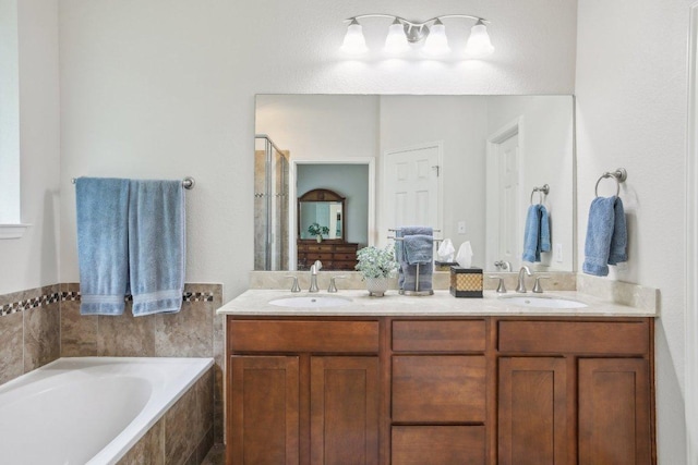 2228 Hilltop Climb Dr, Leander, TX 78641 - full bathroom with a bath, double vanity, and a shower stall