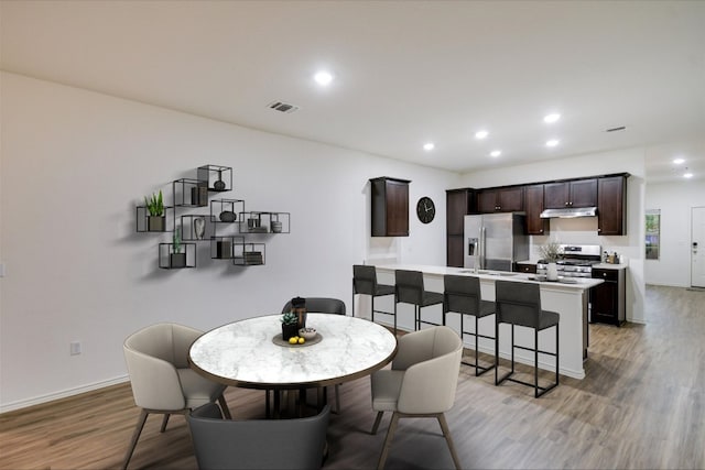 3413 Breckenridge Dr, Austin, TX 78744 - dining room with light wood-type flooring, recessed lighting, and baseboards