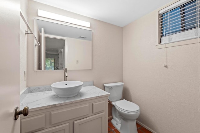 1135 Barton Hills Dr Unit 240, Austin, TX 78704 - bathroom featuring toilet, vanity, and a textured wall
