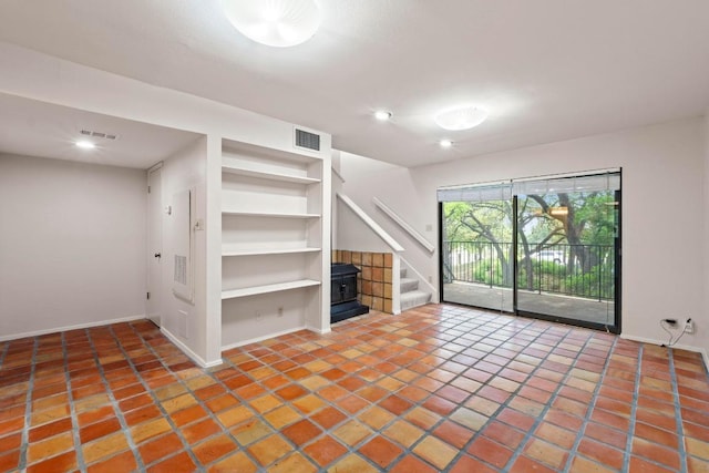 1135 Barton Hills Dr Unit 240, Austin, TX 78704 - unfurnished living room with stairs, recessed lighting, baseboards, tile patterned flooring, and built in features