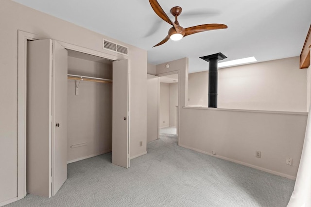 1135 Barton Hills Dr Unit 240, Austin, TX 78704 - unfurnished bedroom featuring light carpet, a closet, baseboards, and a ceiling fan