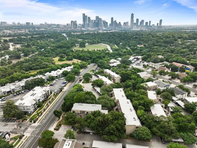 1135 Barton Hills Dr Unit 240, Austin, TX 78704 - drone / aerial view of city skyline and a tree filled landscape