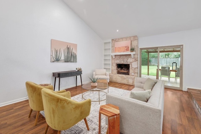 9417 Longvale Dr, Austin, TX 78729 - living area featuring a stone fireplace, lofted ceiling, baseboards, built in features, and wood finished floors