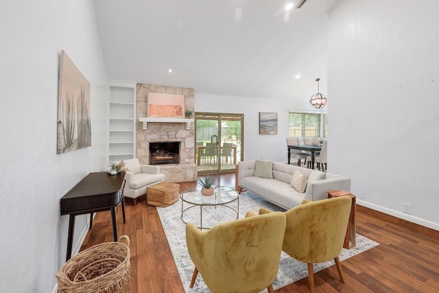 9417 Longvale Dr, Austin, TX 78729 - living room with a stone fireplace, wood finished floors, baseboards, high vaulted ceiling, and recessed lighting