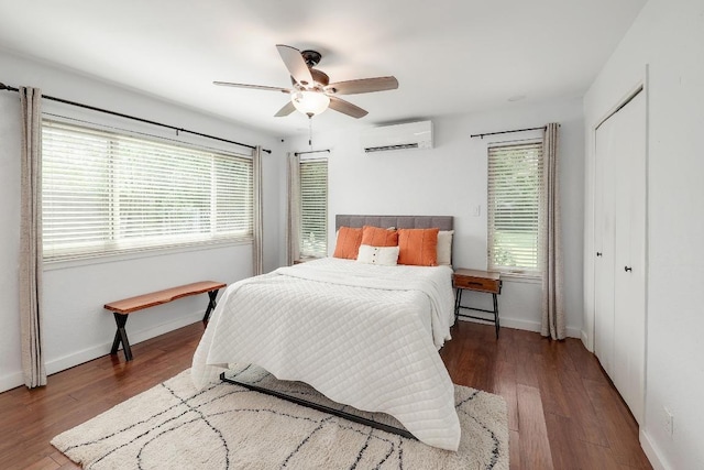 9417 Longvale Dr, Austin, TX 78729 - bedroom with a wall mounted air conditioner, multiple windows, and wood finished floors