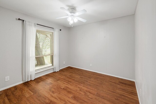 9417 Longvale Dr, Austin, TX 78729 - unfurnished room with wood finished floors, baseboards, and ceiling fan