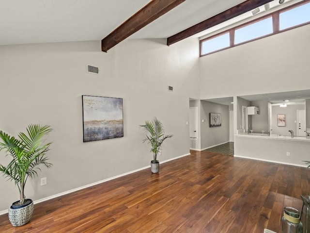 3700 Steck Ave, Austin, TX 78759 - unfurnished living room with wood finished floors, high vaulted ceiling, baseboards, and beamed ceiling