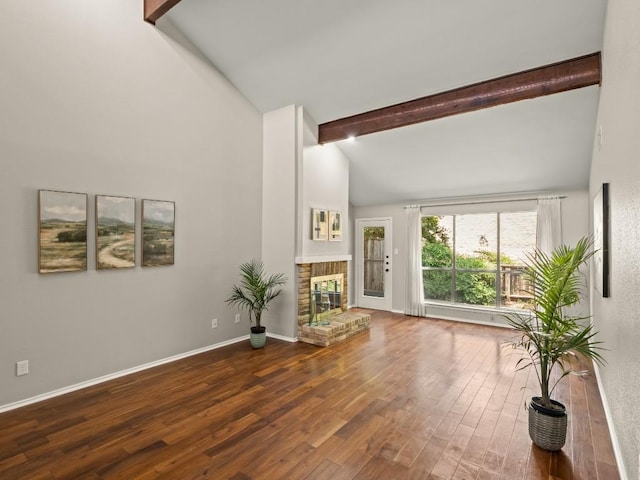 3700 Steck Ave, Austin, TX 78759 - unfurnished living room featuring a fireplace, wood finished floors, beamed ceiling, high vaulted ceiling, and baseboards