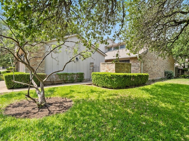 3700 Steck Ave, Austin, TX 78759 - view of property exterior with brick siding and a lawn