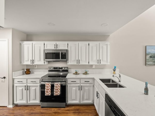 3700 Steck Ave, Austin, TX 78759 - kitchen with appliances with stainless steel finishes, a sink, dark wood-style floors, and light countertops