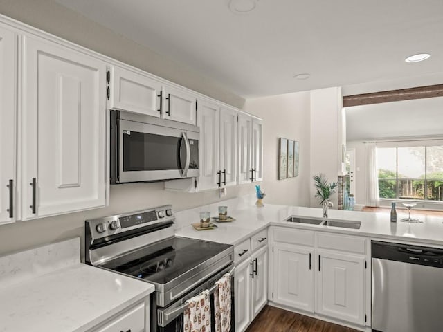 3700 Steck Ave, Austin, TX 78759 - kitchen featuring stainless steel appliances, a sink, white cabinetry, and recessed lighting