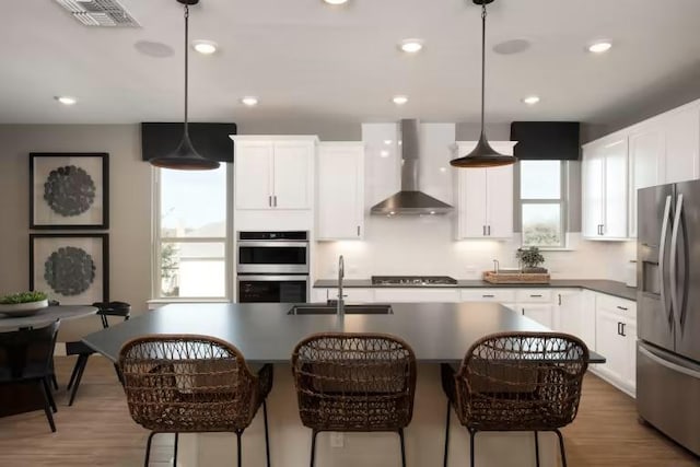 508 Canyoncrest Way, Liberty Hill, TX 78642 - kitchen with appliances with stainless steel finishes, wall chimney range hood, a sink, white cabinetry, and light wood-type flooring