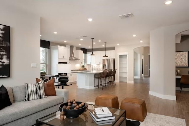 508 Canyoncrest Way, Liberty Hill, TX 78642 - living area with arched walkways, light wood-style floors, recessed lighting, and baseboards