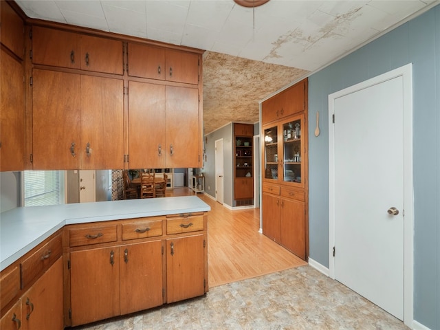 302 Vernon St, Thrall, TX 76578 - kitchen with light countertops, brown cabinetry, light flooring, and baseboards