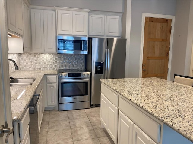 104 Bella Toscana Ave Unit 2106, Austin, TX 78734 - kitchen with stainless steel appliances, a sink, backsplash, light tile patterned floors, and white cabinetry