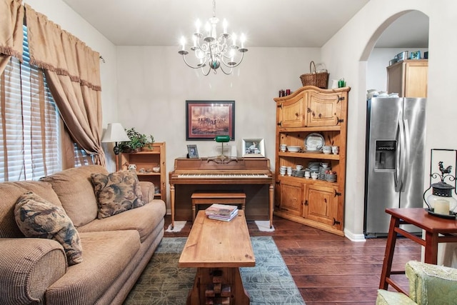 1115 Henderson Dr, Leander, TX 78641 - living area with dark wood-style flooring, arched walkways, and a chandelier