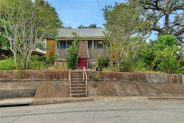 1001 Catalpa St, Austin, TX 78702 - view of front of house with stairway and a sunroom