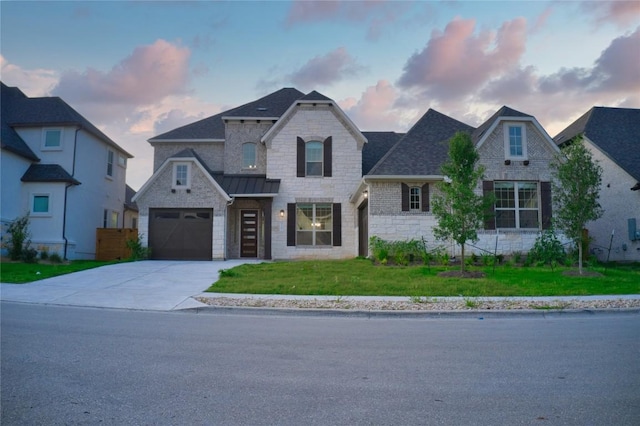 3321 Mongolian Dr, Leander, TX 78641 - french country style house with driveway, a yard, stone siding, a garage, and a shingled roof