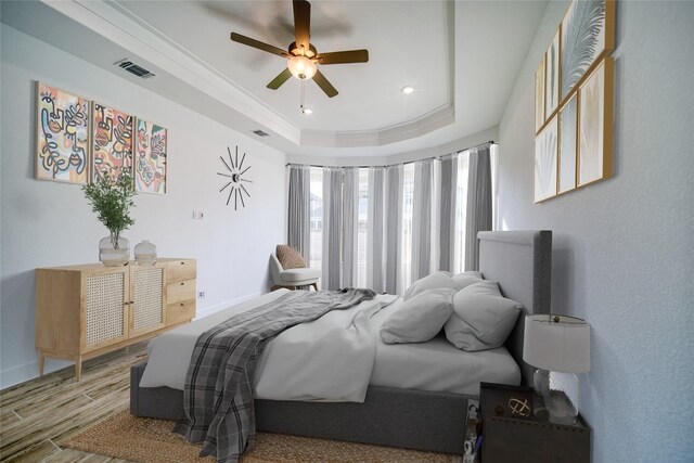 3321 Mongolian Dr, Leander, TX 78641 - bedroom featuring wood finished floors, a tray ceiling, baseboards, and a ceiling fan