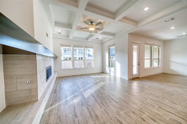 3321 Mongolian Dr, Leander, TX 78641 - unfurnished living room featuring beamed ceiling, a fireplace, light wood finished floors, baseboards, and a ceiling fan