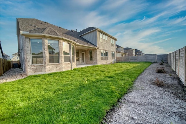 3321 Mongolian Dr, Leander, TX 78641 - rear view of property featuring brick siding, a patio, and roof with shingles