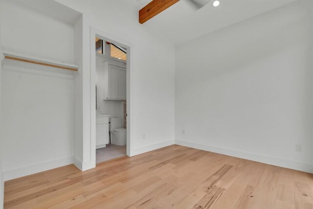 18408 F M Road 1431, Jonestown, TX 78645 - unfurnished bedroom featuring wood finished floors, beam ceiling, and connected bathroom