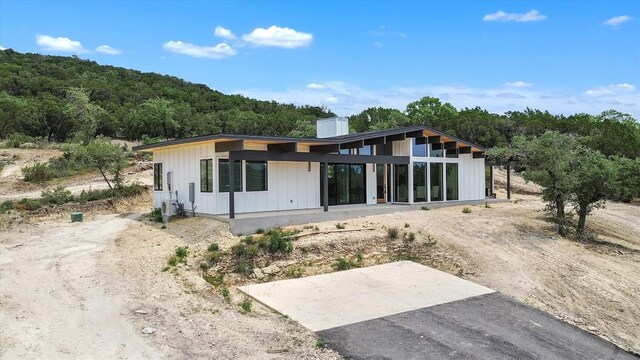 18408 F M Road 1431, Jonestown, TX 78645 - back of property with a view of trees and a chimney
