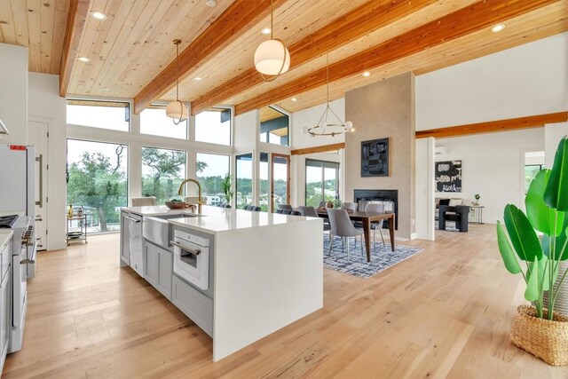 18408 F M Road 1431, Jonestown, TX 78645 - kitchen with beam ceiling, light countertops, pendant lighting, light wood-style floors, and open floor plan
