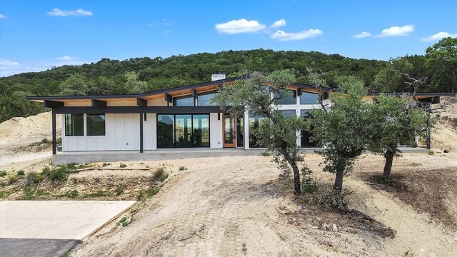 18408 F M Road 1431, Jonestown, TX 78645 - view of front of home featuring board and batten siding and a view of trees