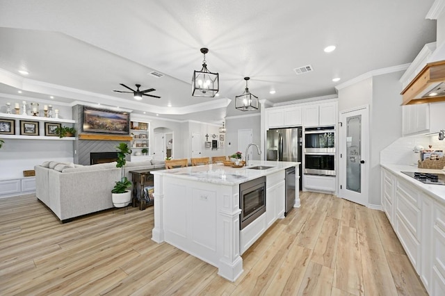 16240 Toby Ct, Temple, TX 76502 - kitchen with crown molding, ceiling fan, appliances with stainless steel finishes, light wood finished floors, and recessed lighting