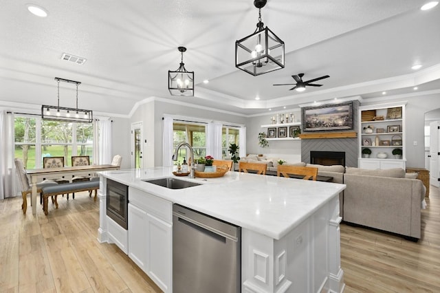 16240 Toby Ct, Temple, TX 76502 - kitchen with dishwasher, a sink, a fireplace, crown molding, and a ceiling fan