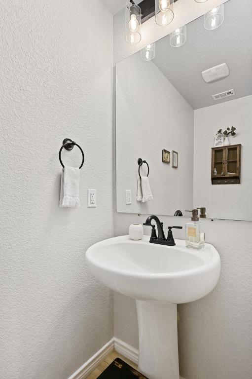 16240 Toby Ct, Temple, TX 76502 - bathroom featuring a sink and baseboards
