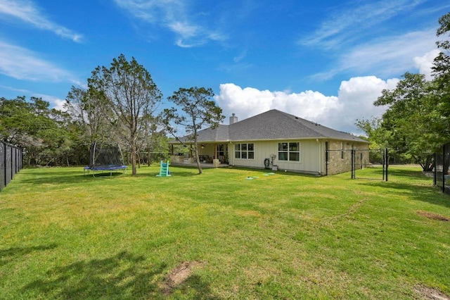 16240 Toby Ct, Temple, TX 76502 - back of house with a trampoline, a chimney, and board and batten siding