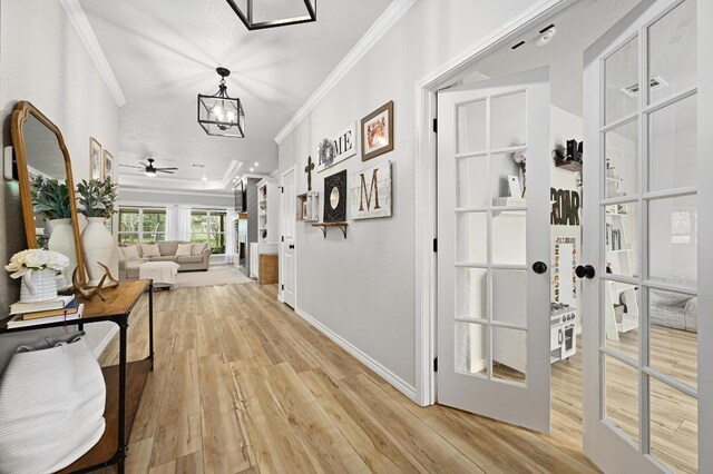 16240 Toby Ct, Temple, TX 76502 - hall featuring crown molding, light wood-style floors, a chandelier, and baseboards