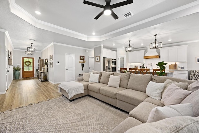 16240 Toby Ct, Temple, TX 76502 - living room with recessed lighting, a chandelier, a raised ceiling, baseboards, and light wood-style flooring
