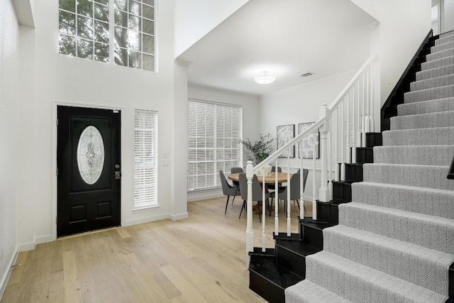 6116 Pebble Garden Ct, Austin, TX 78739 - foyer with stairs, wood finished floors, baseboards, and healthy amount of natural light