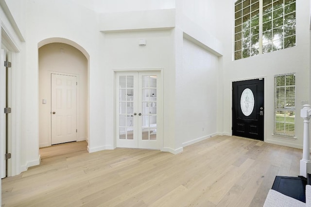 6116 Pebble Garden Ct, Austin, TX 78739 - entryway featuring a high ceiling, french doors, light wood-type flooring, and healthy amount of natural light